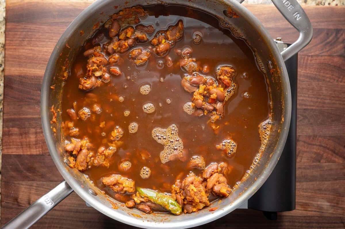 bean cooking liquid added to the beans and masala.
