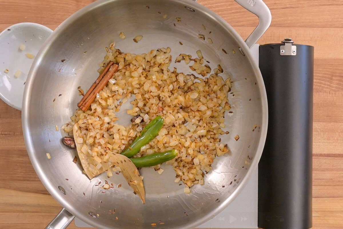 onion and serrano peppers after being cooked with the mixture in the frying pan.