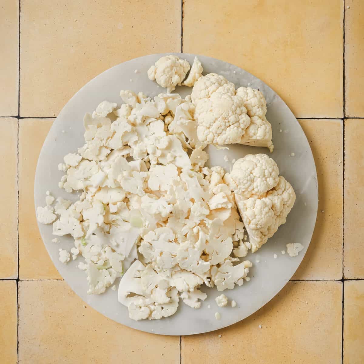 shaved cauliflower on a marble serving board.