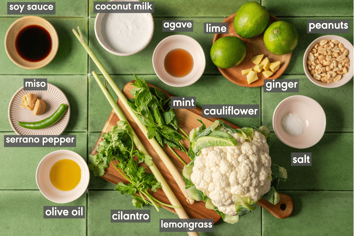 ingredients for cauliflower salad in various small bowls on a table.
