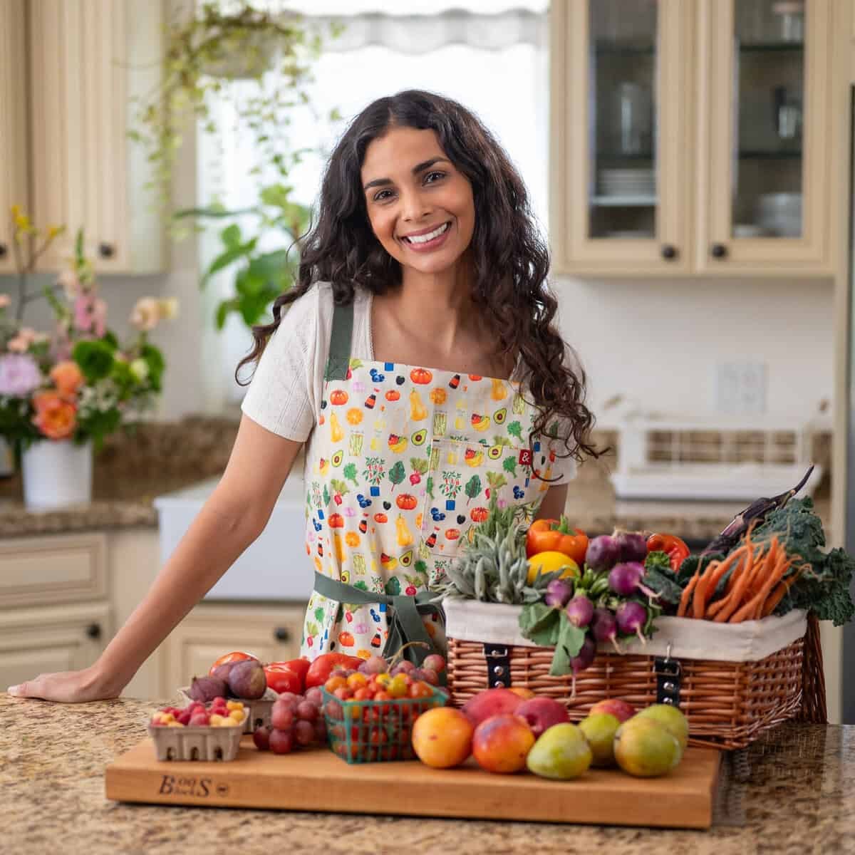 Nisha wearing custom Rainbow Plant Life apron designed with Hedley & Bennett.