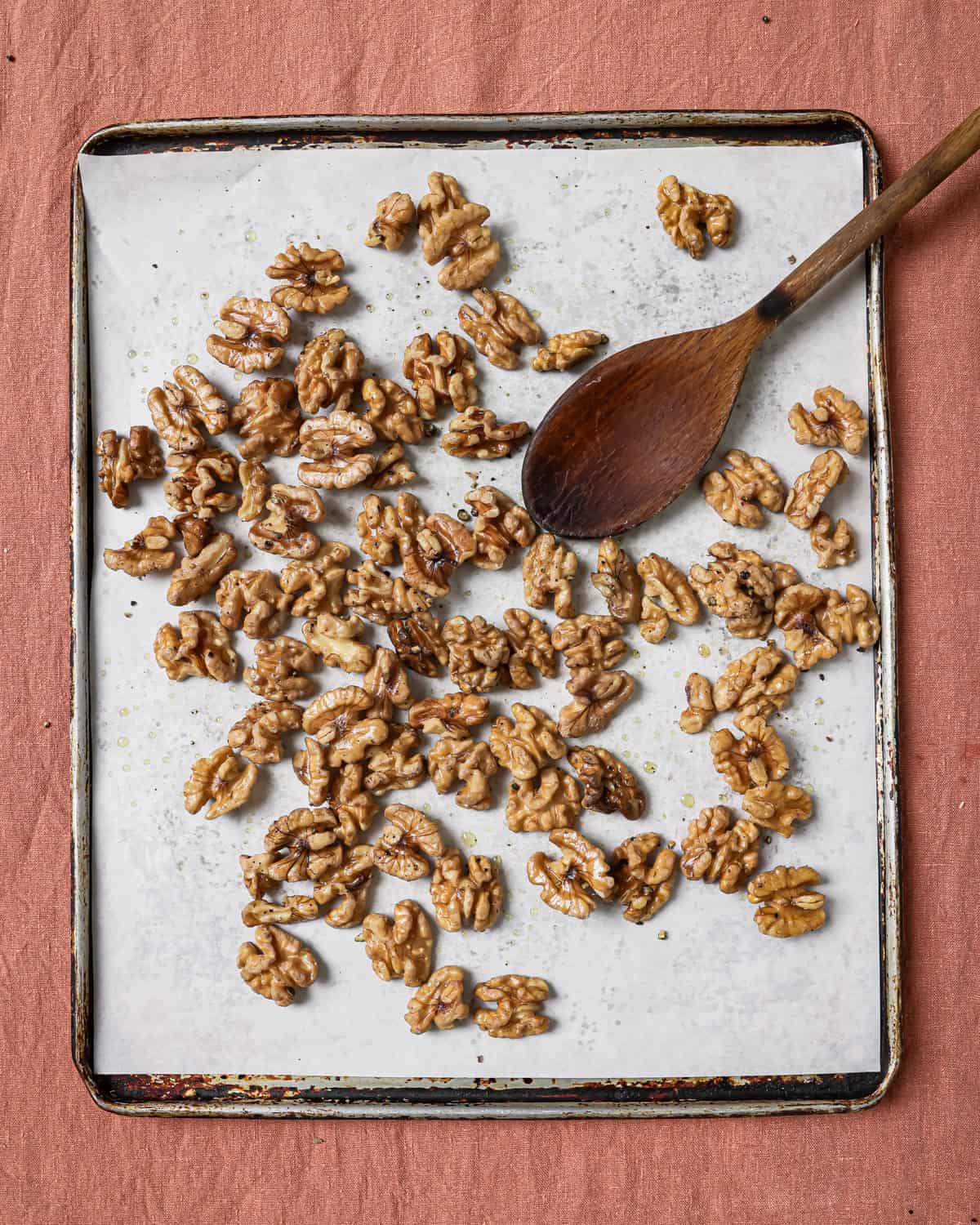 partially roasted walnuts on the baking sheet.