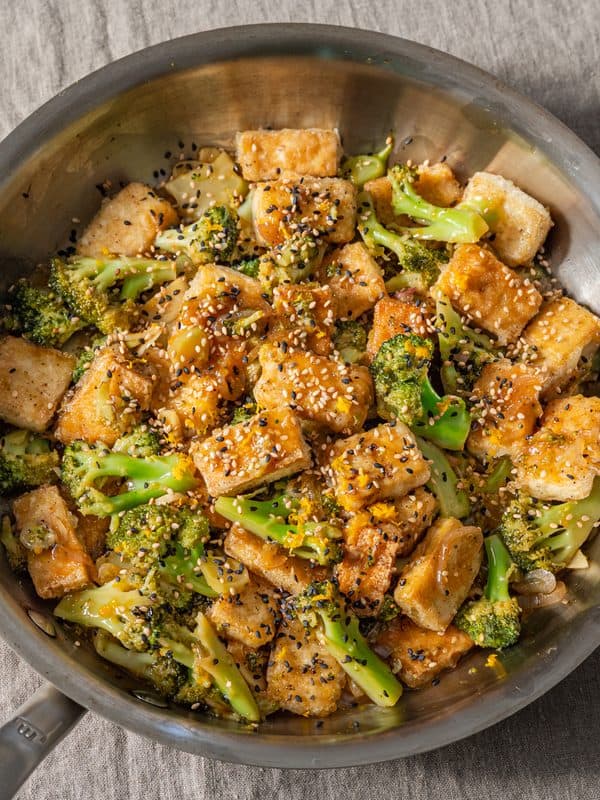 tofu and broccoli stir fry in frying pan.