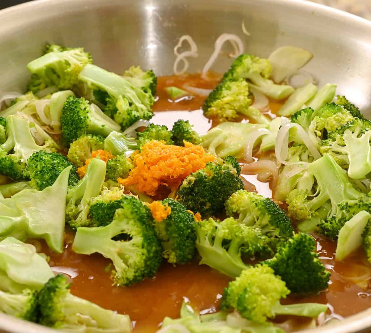 Orange sauce and zest added to the frying pan.