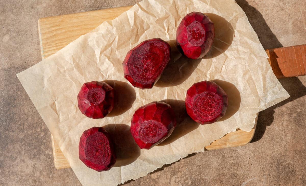 peeled beets without the tops on a piece of parchment paper.