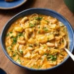 golden cabbage soup in a bowl with a spoon.