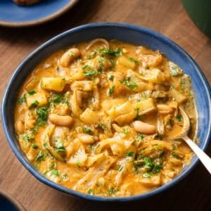 golden cabbage soup in a bowl with a spoon.