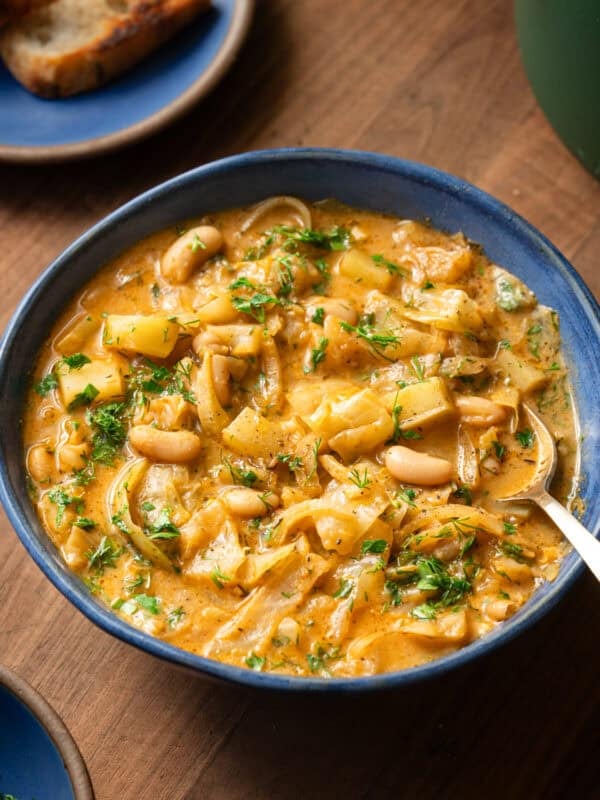 golden cabbage soup in a bowl with a spoon.