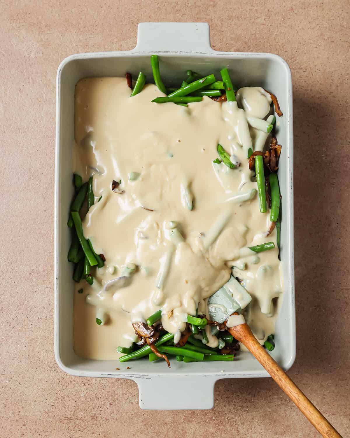 cream sauce poured over the mushrooms and green beans before being mixed.