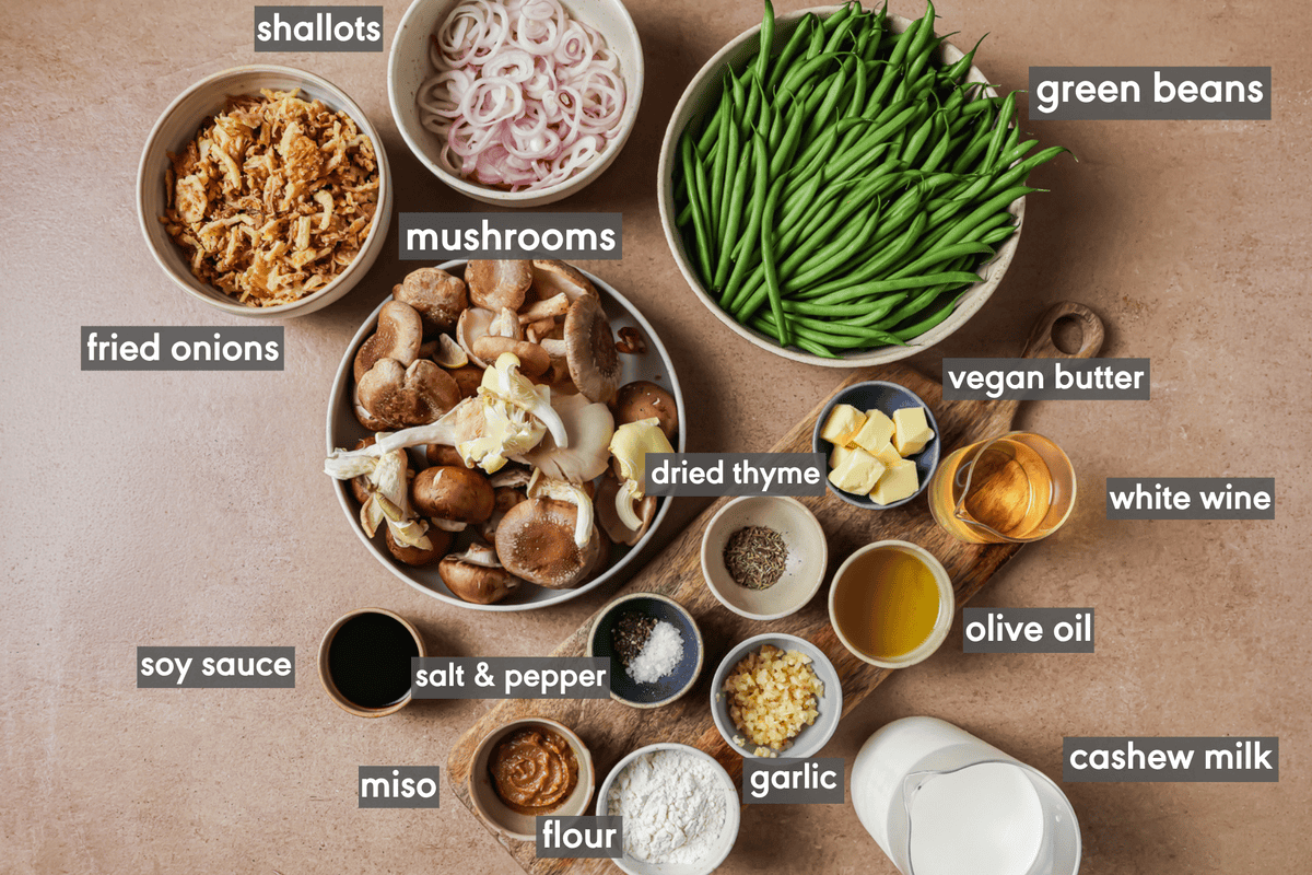 green bean casserole ingredients in various small bowls on a table.